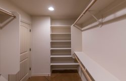 Master closet with shelving and rod and shelf