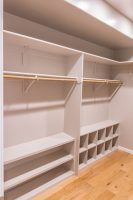 Master walk-in closet with rods, shelves and shoe racks