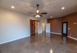 Master bedroom with stained concrete floor