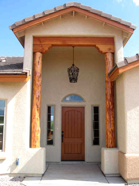 Front doorway of custom home with wood accents.