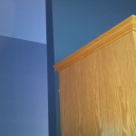 Oak cabinet against blue wall